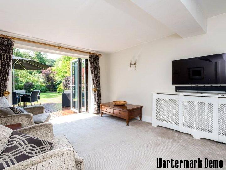 Five-Bedroom Town House on Rue de Rivoli - Living room whose bi-fold doors are folded back onto the terrace and garden